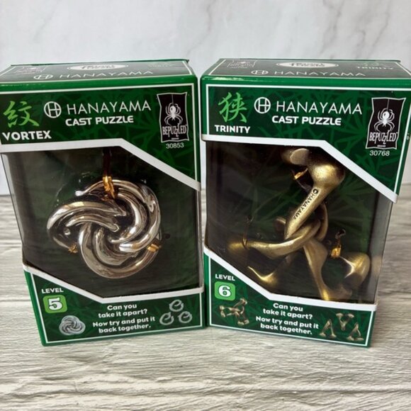 Hanayama Other - NIB Hanayama Cast Metal Brain Teaser Puzzles Vortex & Trinity Set of 2